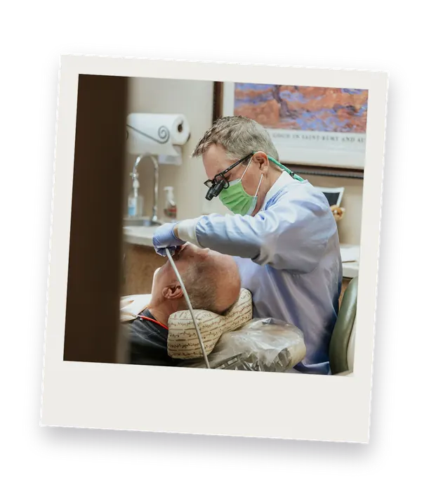 A dentist treating a patient at the Timonium practice