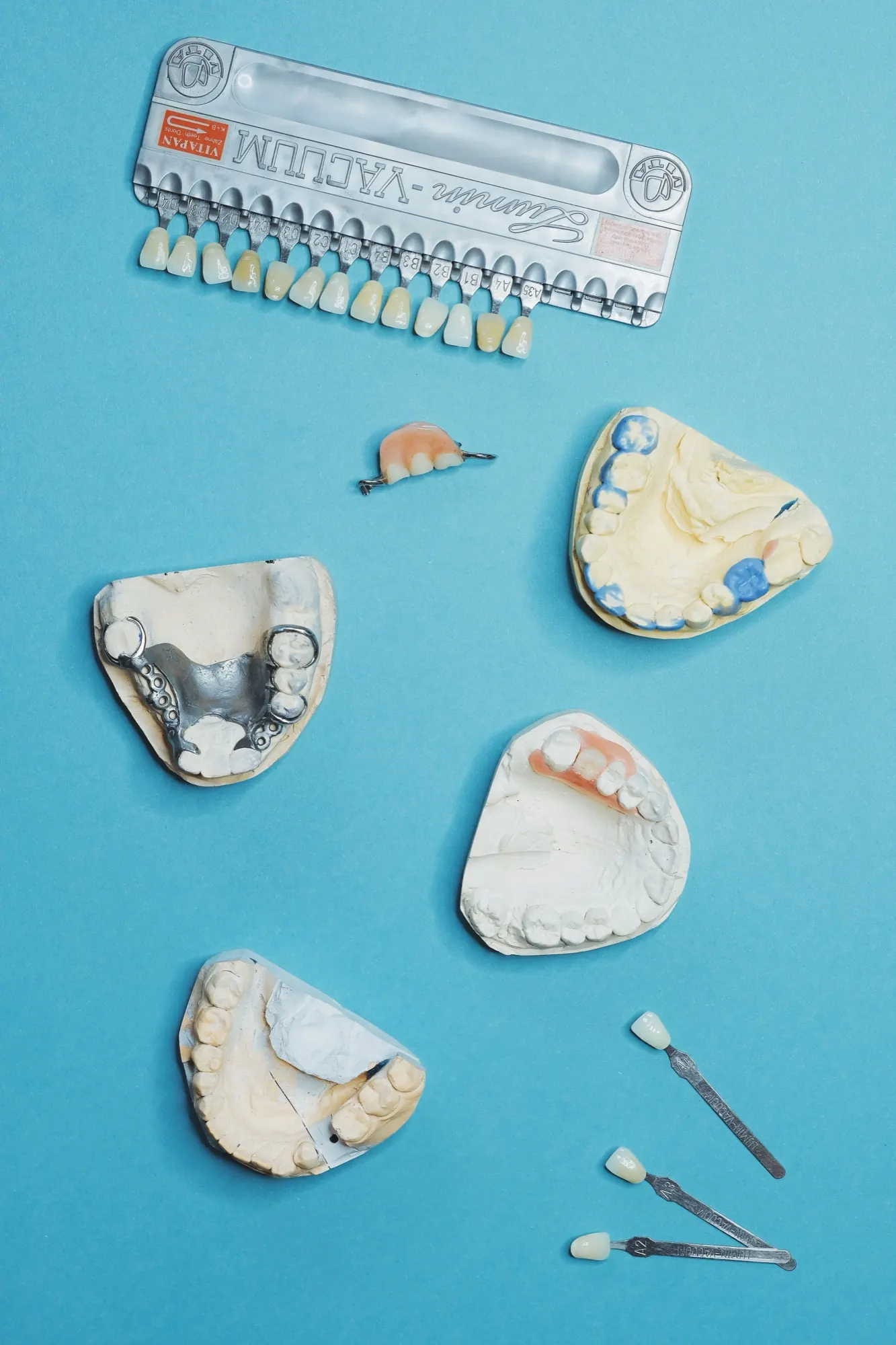 A set of dentures beside a shade guide