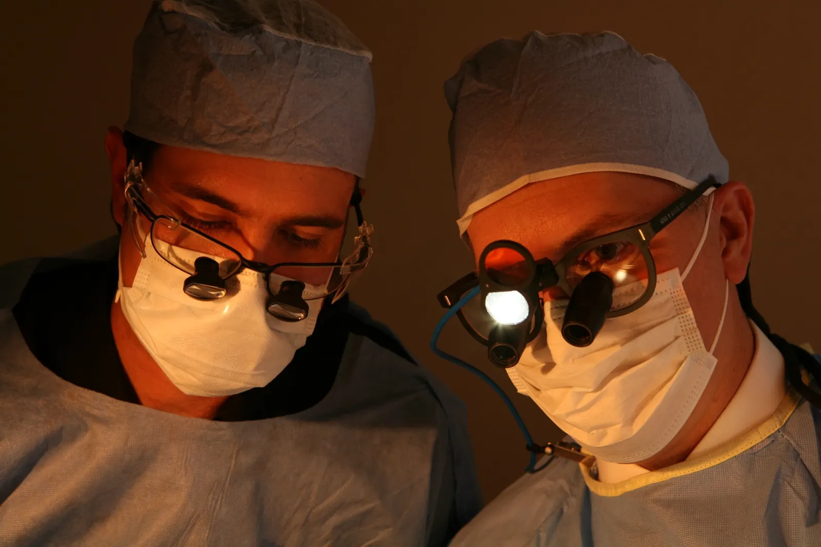 Dentists wearing magnifying loupes during implant surgery