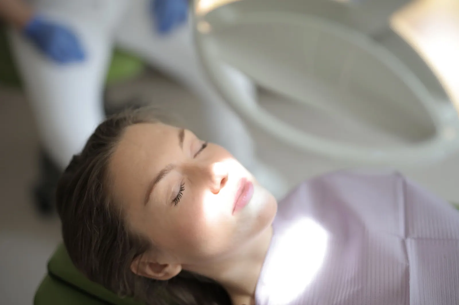 A relaxed patient with eyes closed in a dental chair