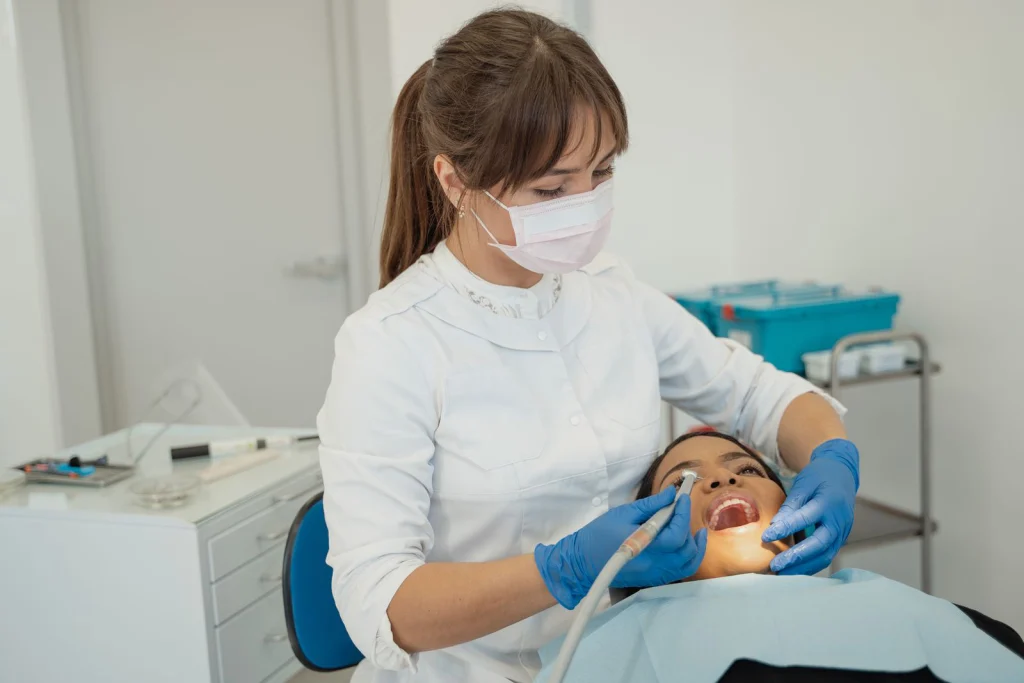 Dentist performing a routine dental check-up on a patient in a modern clinic setting.