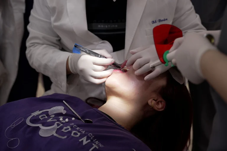 Dentist performing a dental procedure using advanced tools in a modern clinic environment.