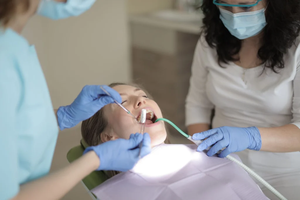 Patient receiving dental care from professionals in a clinic setting.