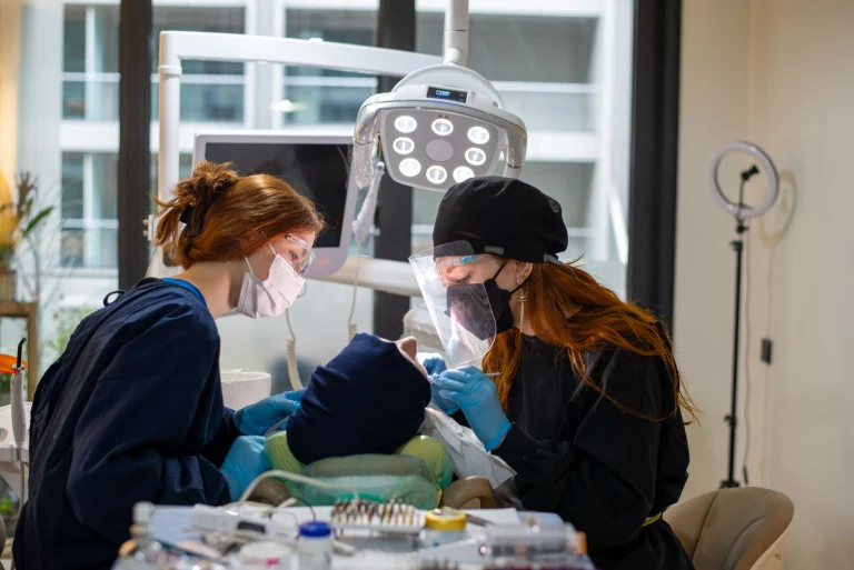 Dentists performing a procedure in a modern clinic with advanced equipment.