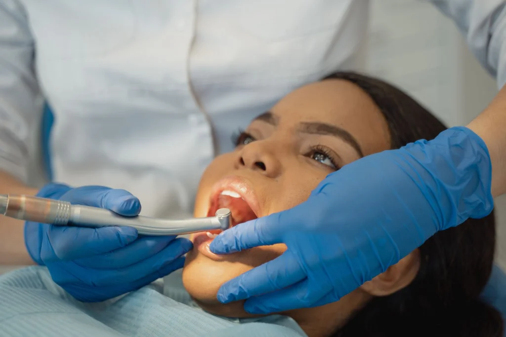 Close-up of a dentist performing a dental treatment on a patient.