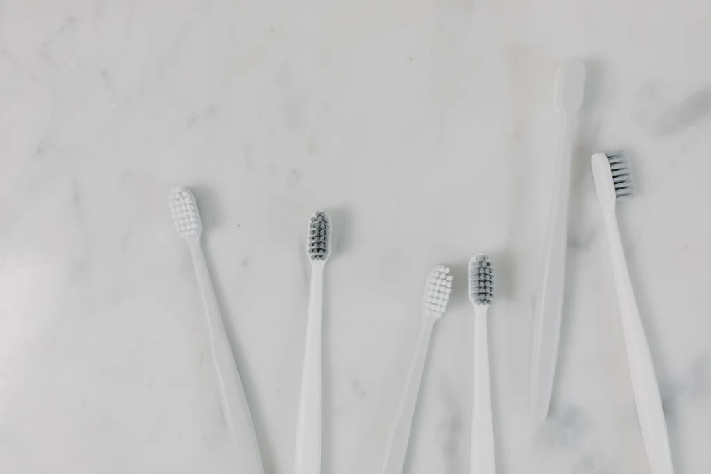 Top view of toothbrushes on a minimalist marble surface, perfect for hygiene themes.
