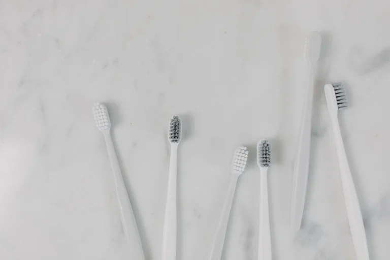 Top view of toothbrushes on a minimalist marble surface, perfect for hygiene themes.